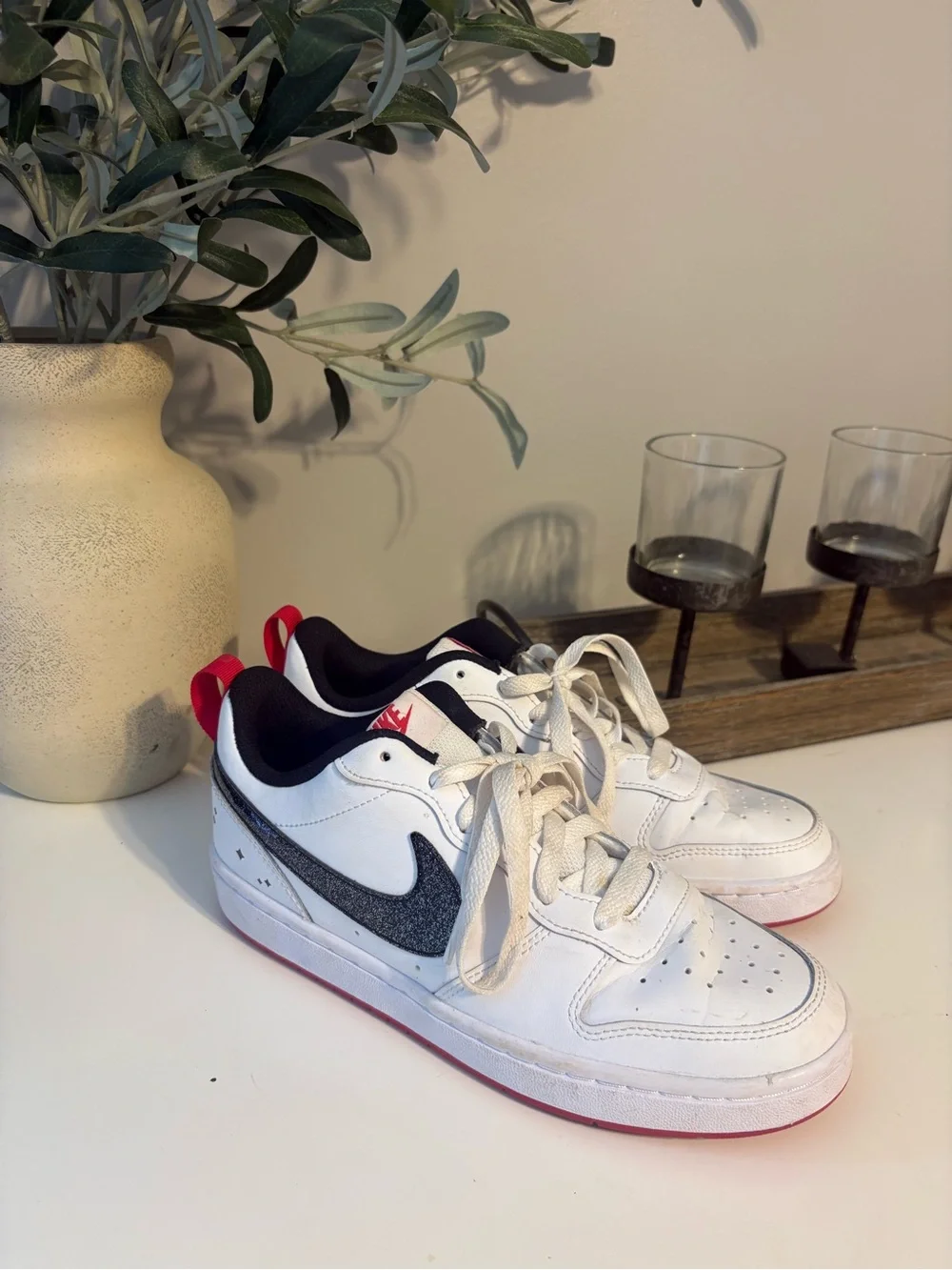 Nike White Low-Top Sneakers with Sparkly Black Swoosh and Red Accents